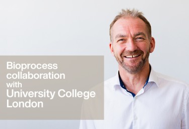 Man smiling against plain background, text referring to the Bioprocess collaboration with University College London