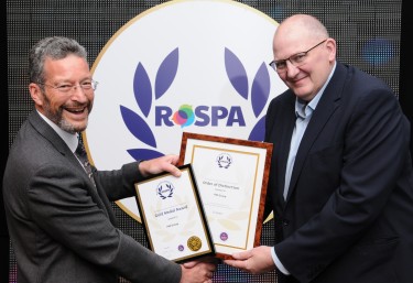 Two men from PM Group holding the RoSPA Gold award