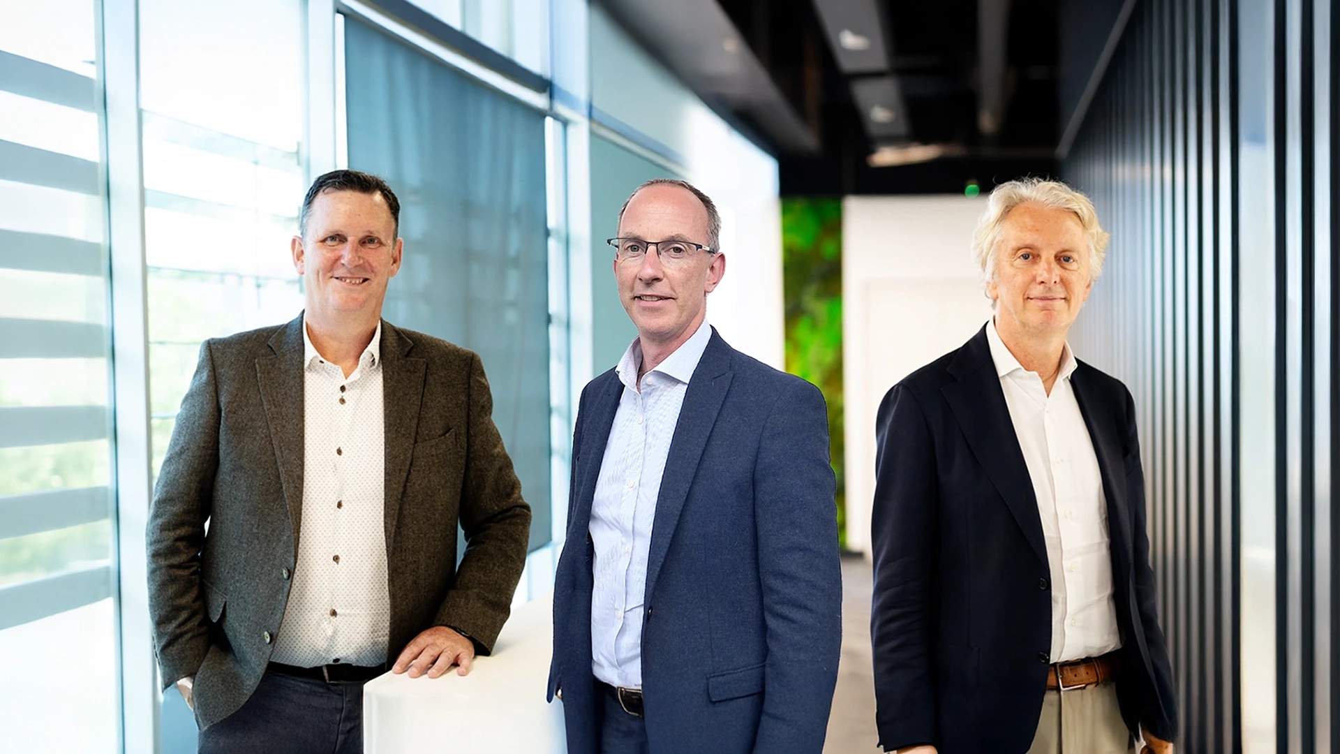 3 men in corporate office environment