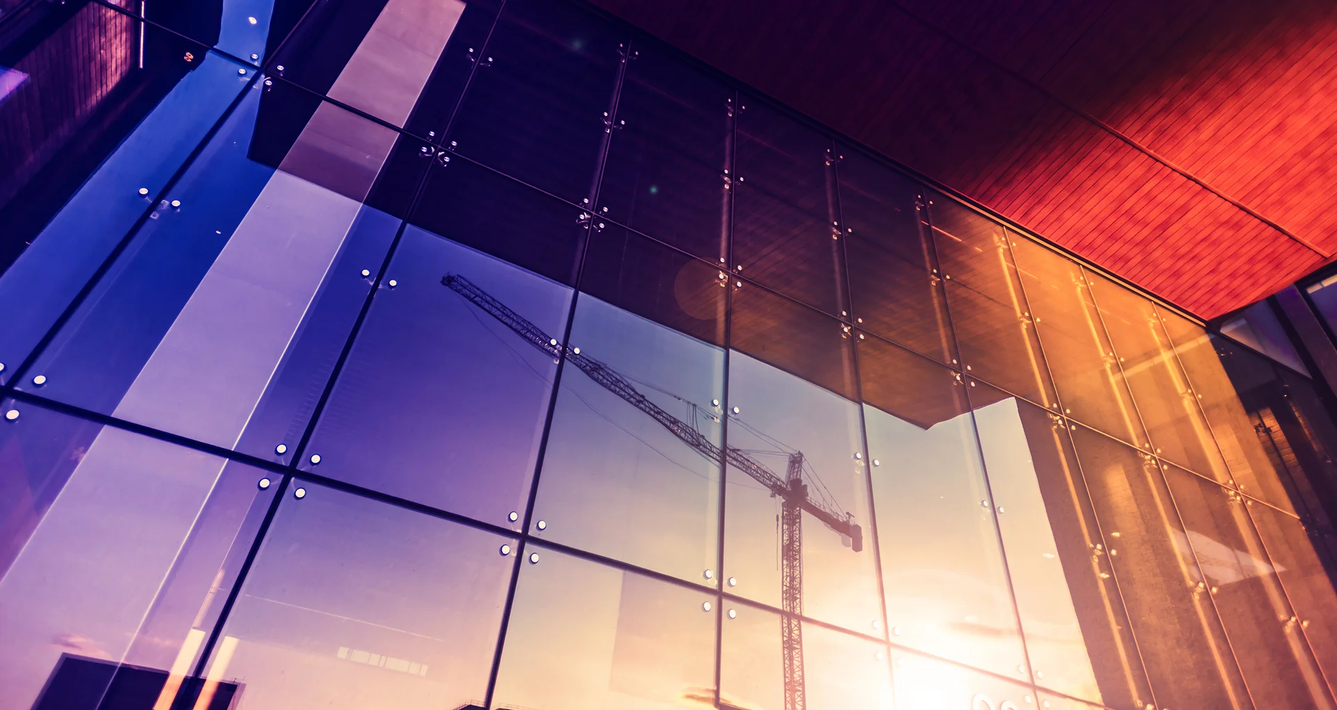Industrial building with reflection of crane in window